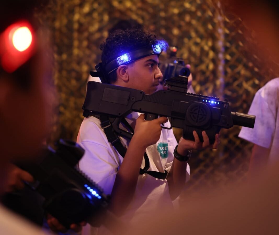 Laser tag players in neon arena at Blackout Field Dammam
